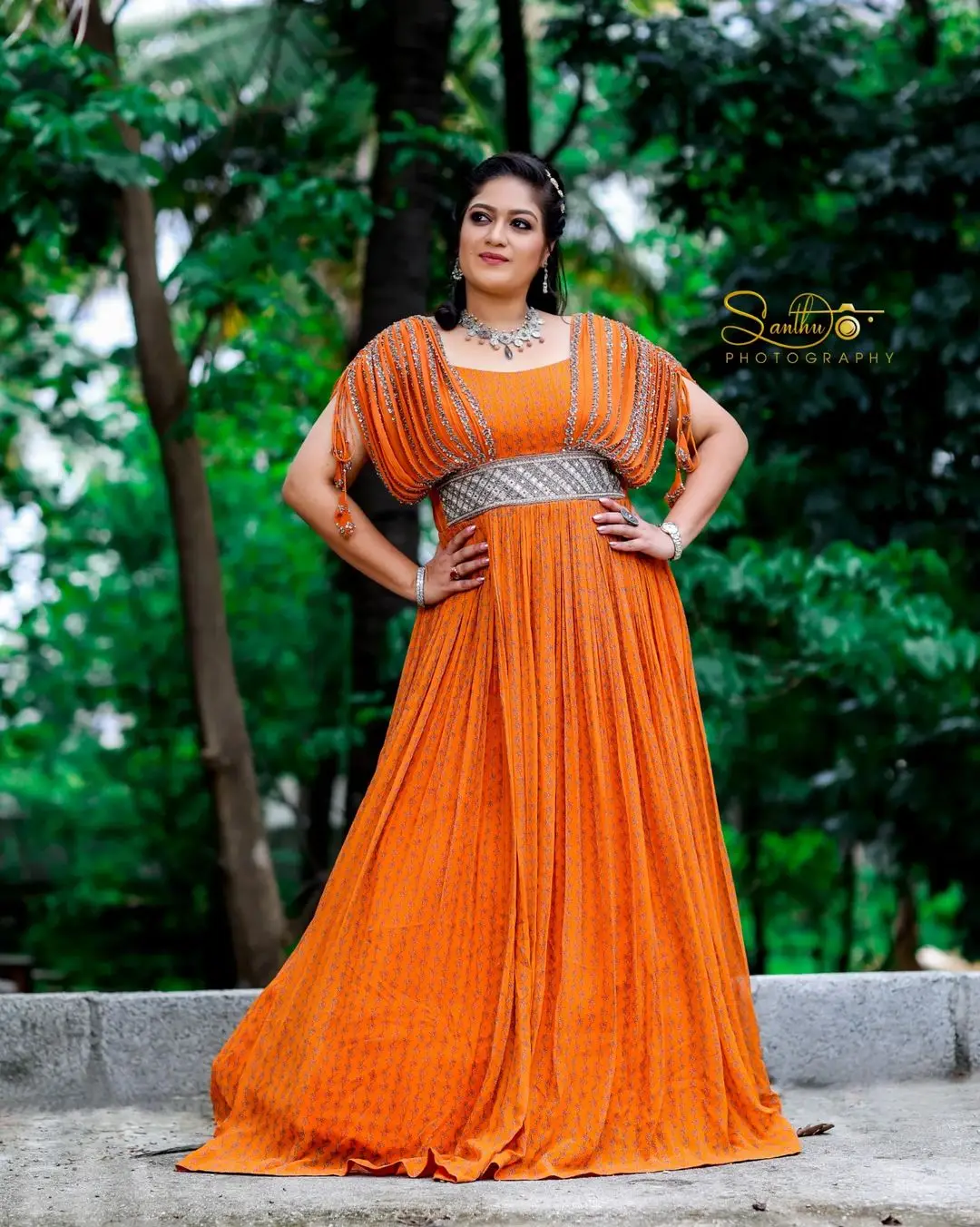 Meghana Raj Wearing Beautiful Earring Jewellery Orange Gown